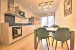 Modern apartment with open-plan kitchen and dining area.