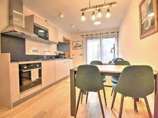 Modern apartment with open-plan kitchen and dining area.