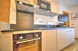 Modern kitchen with built-in oven, microwave, and sleek cabinetry.