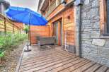 This stunning property boasts a private patio with a wooden deck, perfect for outdoor relaxation.