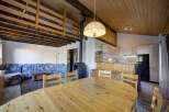 This charming property boasts a cozy living space with a unique wooden ceiling design.