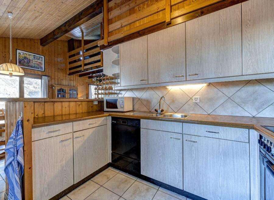 This charming kitchen boasts a rustic design with wooden accents and a cozy atmosphere.