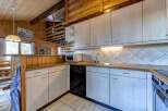 This charming kitchen boasts a rustic design with wooden accents and a cozy atmosphere.