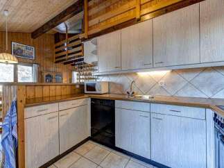 This charming kitchen boasts a rustic design with wooden accents and a cozy atmosphere.