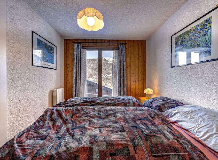 Cozy bedroom with a mountain view.