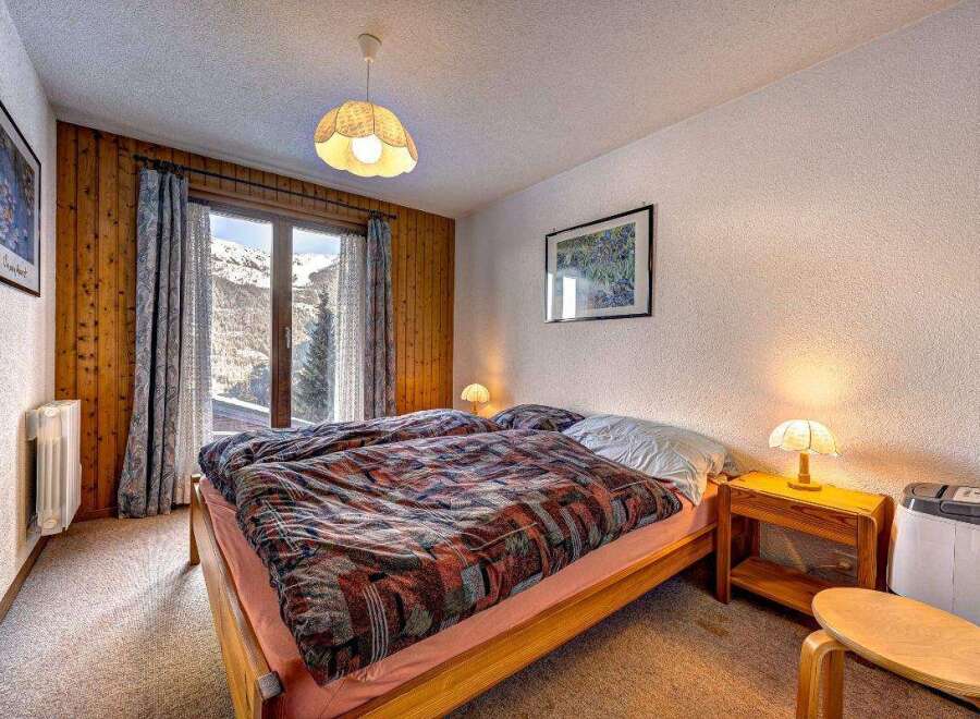 Cozy bedroom with a stunning mountain view.