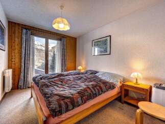 Cozy bedroom with a stunning mountain view.