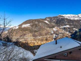 Experience the charm of a snow-covered chalet nestled in the heart of the mountains.