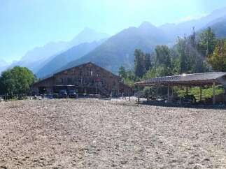 Discover a stunning equestrian property nestled in a picturesque mountain setting.
