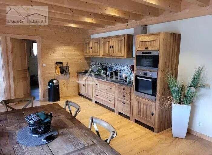 Discover the charm of this rustic kitchen, featuring warm wooden cabinetry and a cozy ambiance.