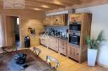 Discover the charm of this rustic kitchen, featuring warm wooden cabinetry and a cozy ambiance.