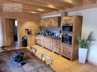 Discover the charm of this rustic kitchen, featuring warm wooden cabinetry and a cozy ambiance.
