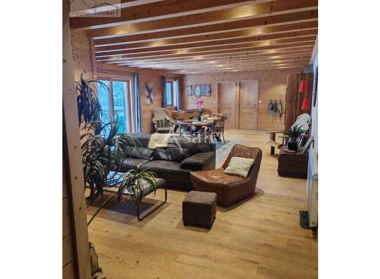 Discover the charm of this stunning property, featuring a warm and inviting interior with exposed wooden beams and flooring.