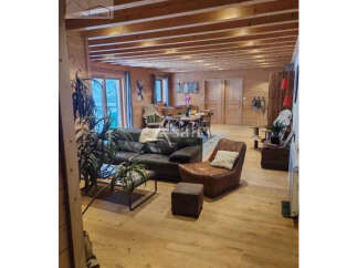 Discover the charm of this stunning property, featuring a warm and inviting interior with exposed wooden beams and flooring.