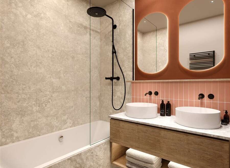 Modern bathroom with double sinks, a bathtub, and a walk-in shower.