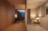 Luxurious bedroom with ensuite bathroom and mountain views.