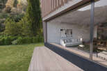 Modern house with large windows showcasing stunning views of nature.