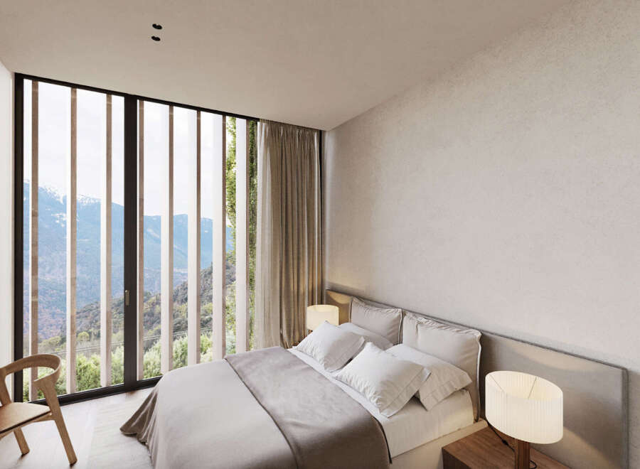 Wake up to breathtaking mountain views from this luxurious bedroom.