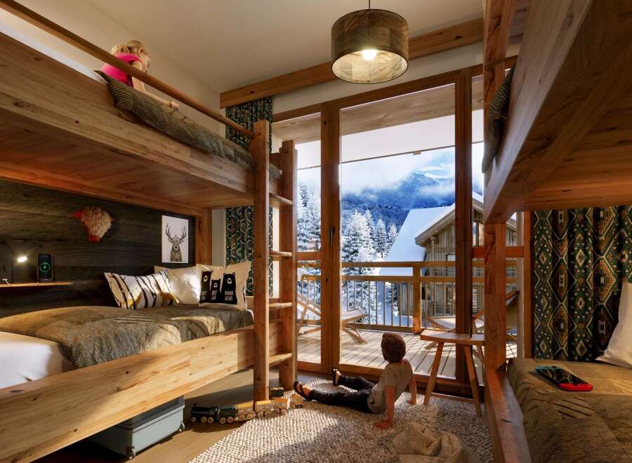 This stunning chalet boasts a spacious kids' room with two sets of bunk beds, perfect for families.