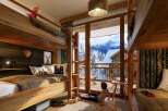 This stunning chalet boasts a spacious kids' room with two sets of bunk beds, perfect for families.