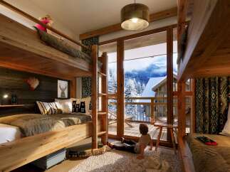 This stunning chalet boasts a spacious kids' room with two sets of bunk beds, perfect for families.