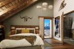 Luxury chalet bedroom with stunning mountain views.