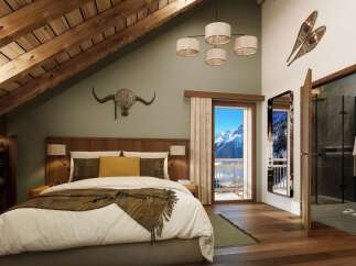 Luxury chalet bedroom with stunning mountain views.