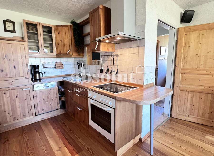 Discover a charming kitchen with wooden cabinetry and a cozy atmosphere.