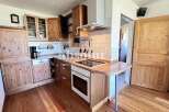 Discover a charming kitchen with wooden cabinetry and a cozy atmosphere.