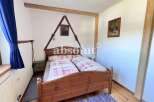 Charming bedroom with a rustic wooden bed frame and cozy bedding.