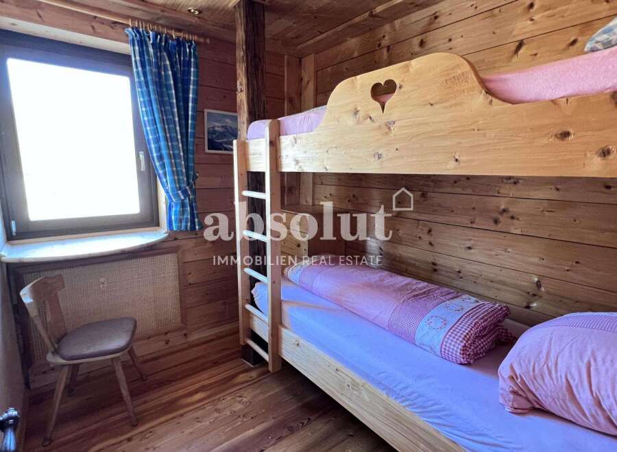 Cozy wooden bunk beds in a charming cabin setting.