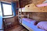 Cozy wooden bunk beds in a charming cabin setting.
