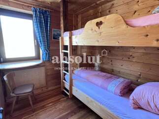 Cozy wooden bunk beds in a charming cabin setting.