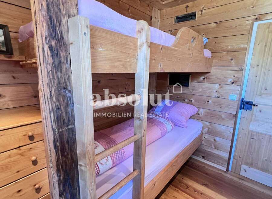 Cozy wooden bunk beds offer a rustic charm in this inviting space.