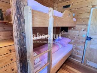 Cozy wooden bunk beds offer a rustic charm in this inviting space.