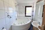 Discover a luxurious bathroom with a modern jacuzzi tub, perfect for relaxation.