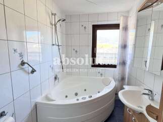 Discover a luxurious bathroom with a modern jacuzzi tub, perfect for relaxation.
