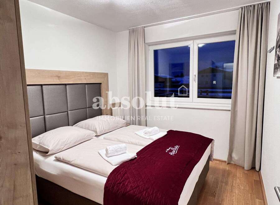 Cozy bedroom with a comfortable bed and a stylish headboard.