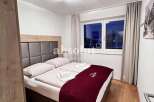Cozy bedroom with a comfortable bed and a stylish headboard.