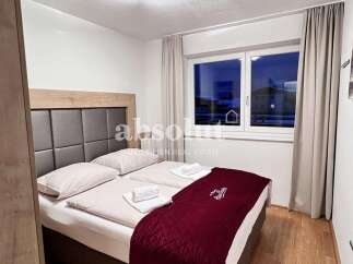 Cozy bedroom with a comfortable bed and a stylish headboard.