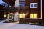 Discover the charm of this stunning property, featuring a beautiful wooden facade and inviting balconies.