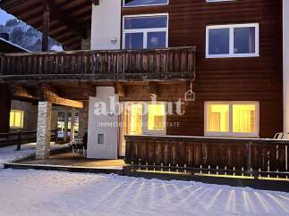Discover the charm of this stunning property, featuring a beautiful wooden facade and inviting balconies.