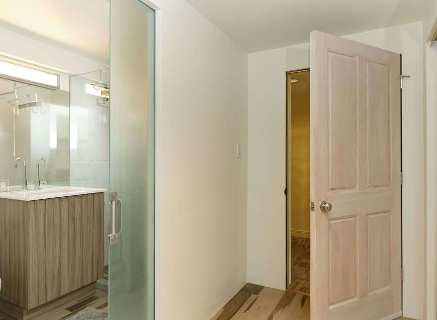 This stunning bathroom boasts a modern design with a sleek glass shower enclosure and a stylish wood vanity.