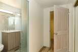This stunning bathroom boasts a modern design with a sleek glass shower enclosure and a stylish wood vanity.