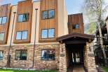 Discover modern luxury at this stunning property featuring a blend of natural stone and warm wood accents.