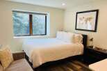 This cozy bedroom features a comfortable bed with crisp white linens, perfect for a relaxing retreat.