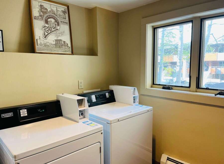 This laundry room features modern Maytag commercial washers and dryers, perfect for convenient in-unit laundry.