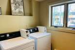 This laundry room features modern Maytag commercial washers and dryers, perfect for convenient in-unit laundry.