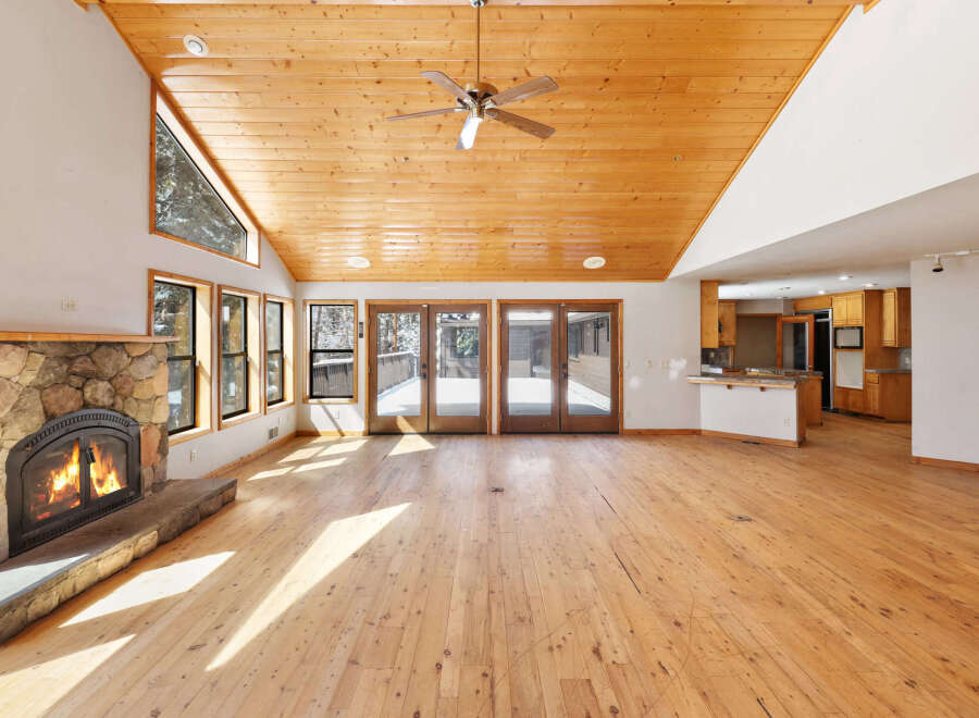 This stunning property boasts a spacious open-plan living area with soaring ceilings and large windows that bathe the room in natural light.