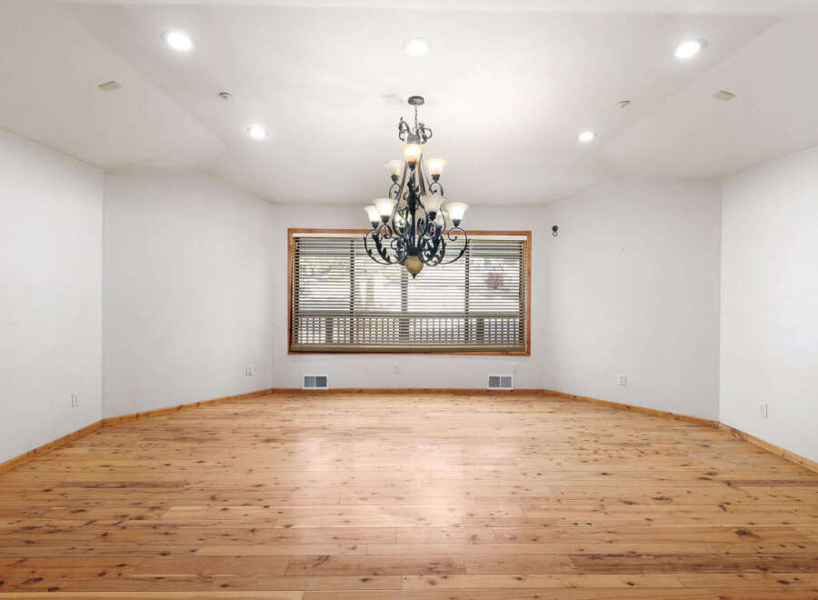This stunning property boasts a spacious dining room with gleaming hardwood floors and a large window that bathes the room in natural light.